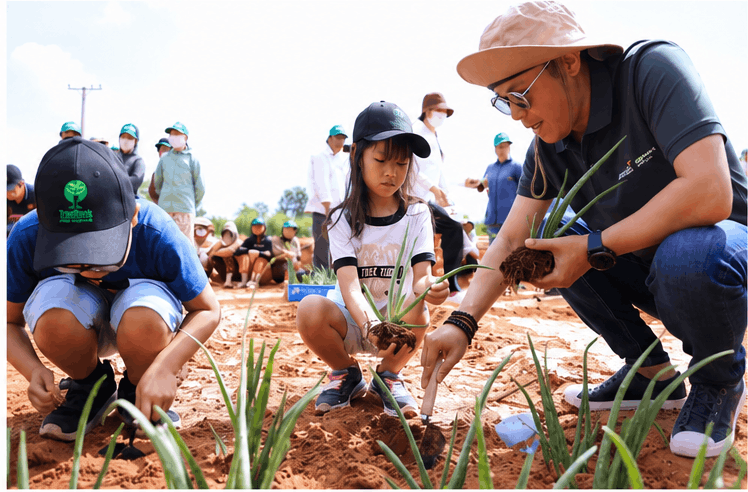 Volunteers and children planting trees together during Tree Planting Day 3/3